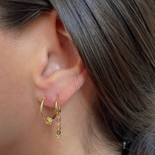 gold huggie earrings tourmaline earrings up close on model