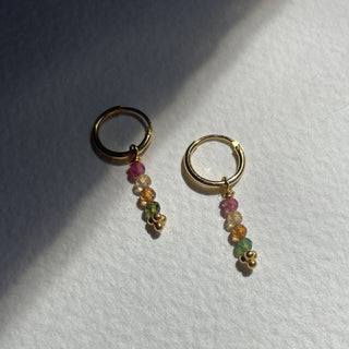 gold huggie earrings tourmaline earrings up close